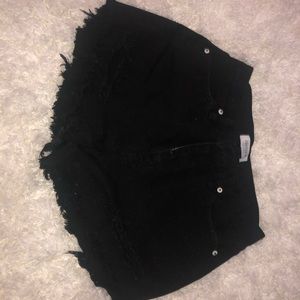 Distressed high rise black shorts.